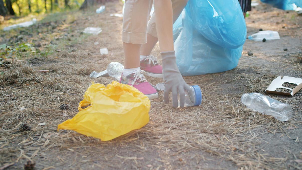 person picking up a piece of trash