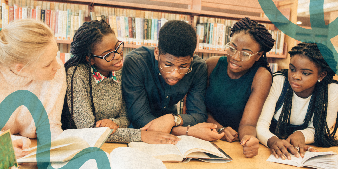 group of students looking at a book