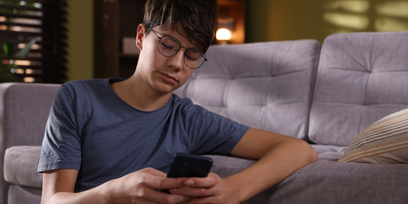 young man scrolling on his phone