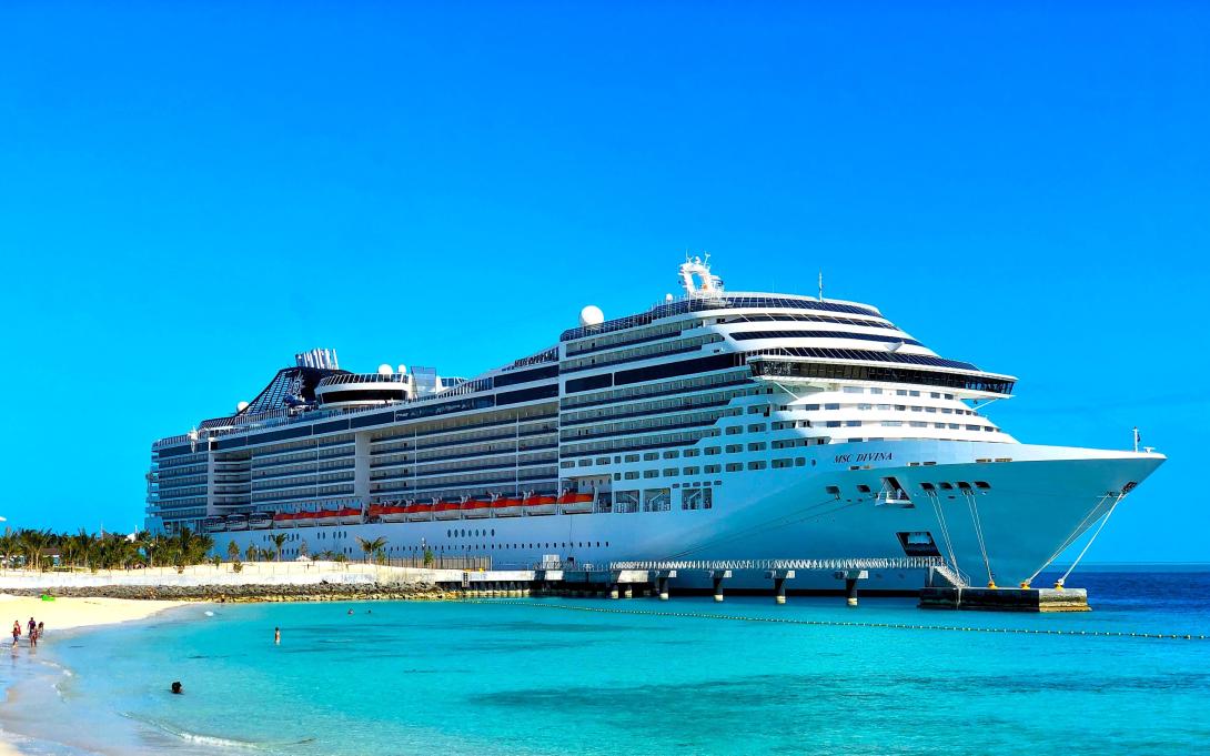 A cruise ship docked at a beach