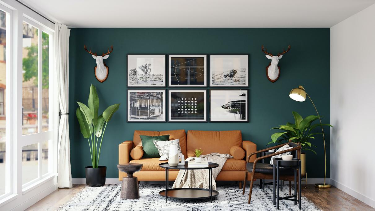 a living room with a blue wall, a couch, wall art and plants