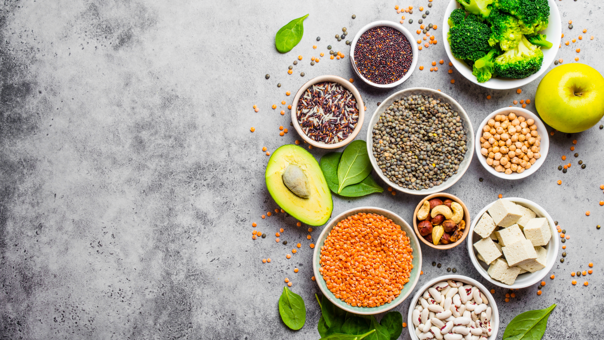 an assortment of vegetarian foods on a gray background