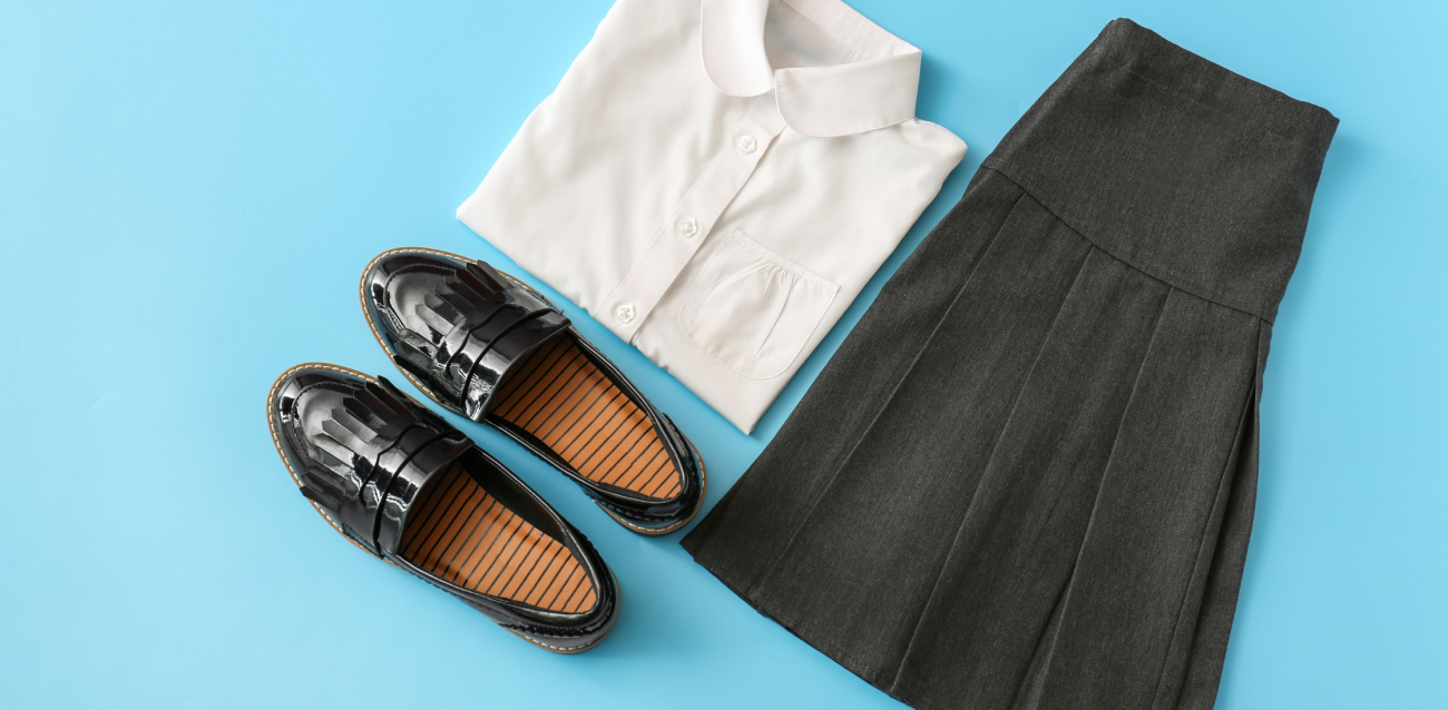 a white shirt, black shoes and black skirt on a blue background